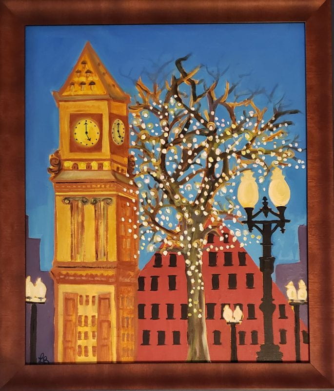 The Custom House Tower in the evening with an illuminated tree and city buildings in the background.