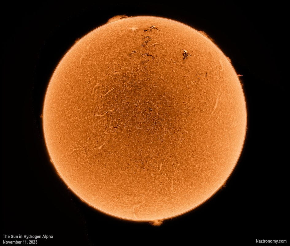 The Sun revealed in Hydrogen Alpha showing prominences, filaments, sunspots, and a dynamic solar surface.
