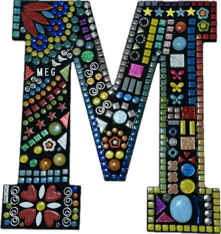 Tall wooden initial letter colorfully decorated using mosaic technique. Beads and small tiles of different colors make up little stars and flowers and glittery patches. Mini birds and curving shapes from silver are also present. The name "MEG" is formed subtly with silver characters at one point.
