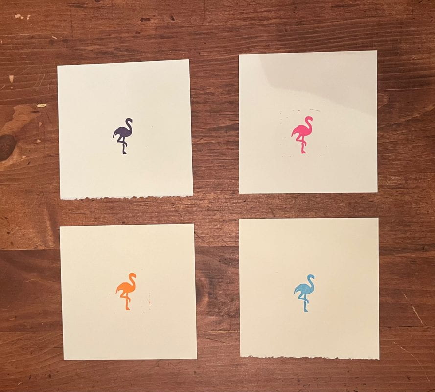 Four individual prints of flamingos, in purple, orange, pink, and blue - colors associated with the tropics