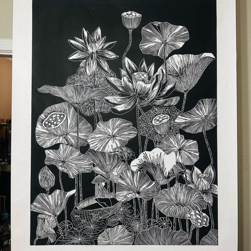 Black and white line work of lotus leaves and flowers on a 3x4 wood block.