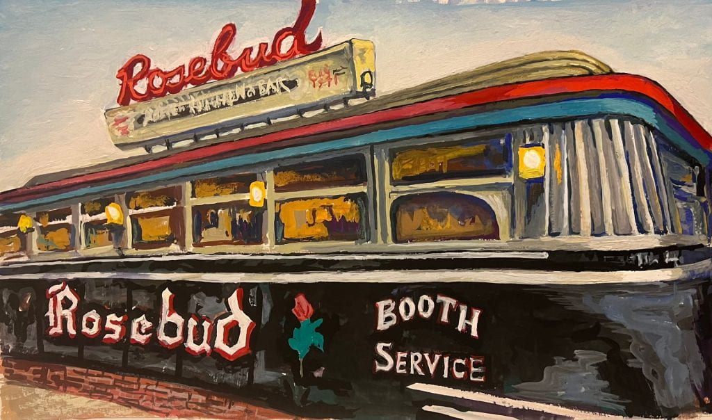 A standalone diner. A sign reading "Rosebud" is seen atop the building, and on its front. Windows and yellow lights line the front facade.