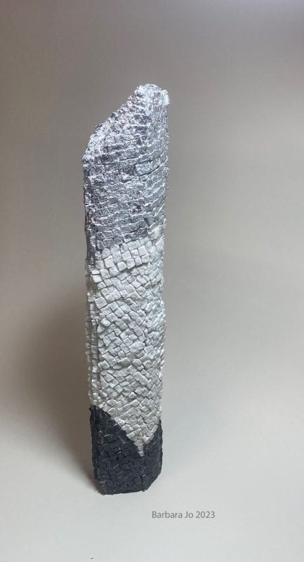 Dark gray, light green, and silver roughly cut stone mosaics on two-foot full round shaft.
