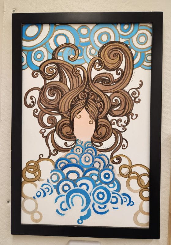 An abstract woman made of and decorated with swirls and spirals.