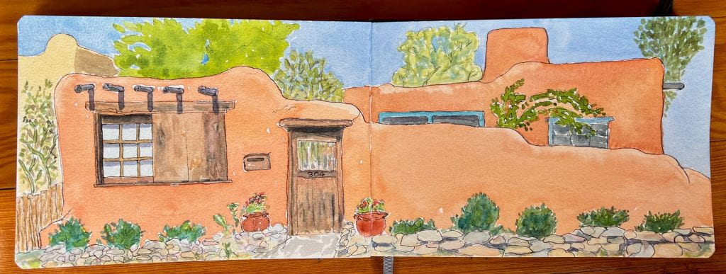 A full spread of my watercolor sketchbook of painting at 304 Delgado Road, Santa Fe, New Mexico. Adobe house with plants, trees.