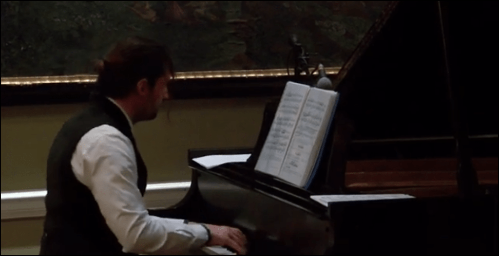 Still from a Youtube video of Evan Katsarelis performing piano.